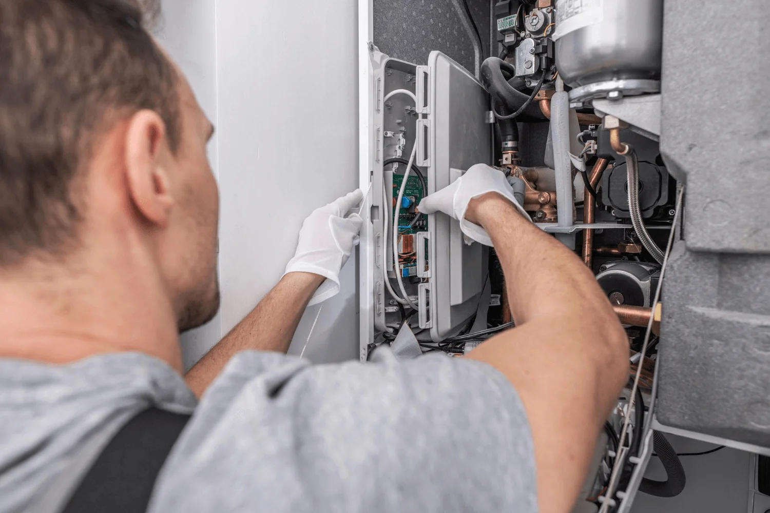 Engineer repairing gas boiler system.