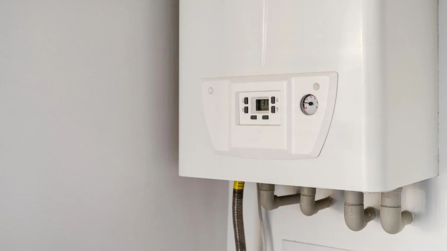 Modern white boiler with digital control panel.